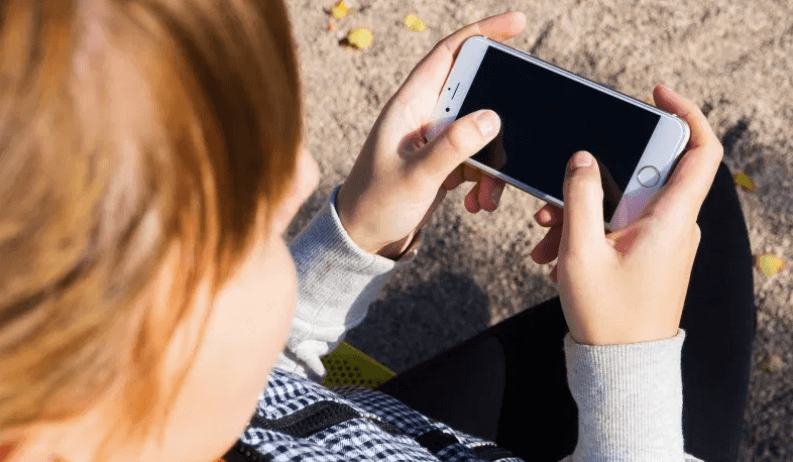 A girl holding a kid-safe cell phone